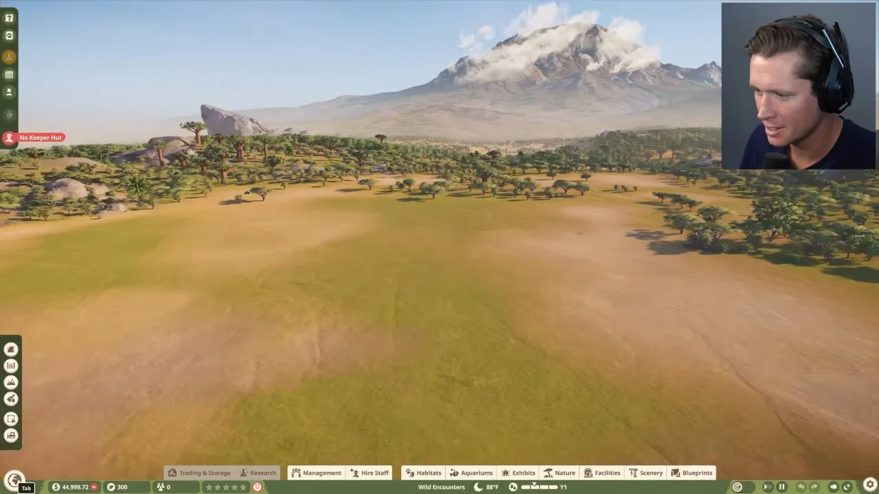 Planet Zoo 2 biomes and terrain, open grassland zoo foreground with a distant mountain